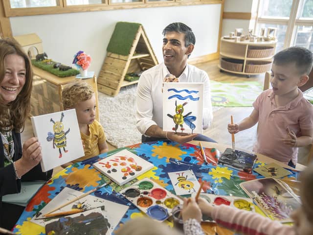 Prime Minister Rishi Sunak and Education Secretary Gillian Keegan hold images of bees they created during a visit to the Busy Bees nursery in Harrogate, North Yorkshire, on August 21, 2023. (Photo by Danny Lawson - WPA Pool/Getty Images)
