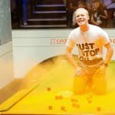 File photo dated 17-04-2023 of A Just Stop Oil protester after jumping on the table and throwing orange powder. Former World Snooker chairman Barry Hearn has called for tougher punishments for protesters after play was disrupted at the World Championship in Sheffield.
