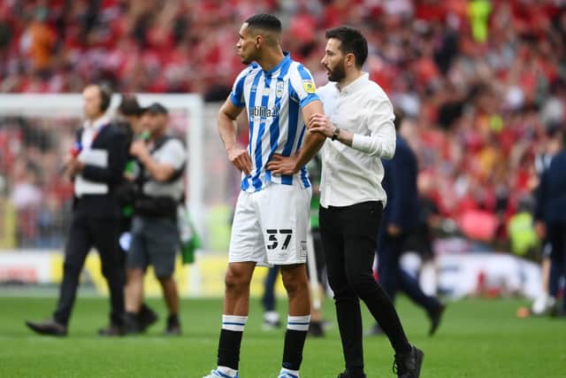 LONDON, ENGLAND - MAY 29: Huddersfield Manager Carlos Corberan consoles Jon Russell of Huddersfield following the Sky Bet Championship Play-Off Final match between Huddersfield Town and Nottingham Forest at Wembley Stadium on May 29, 2022 in London, England. (Photo by Mike Hewitt/Getty Images)