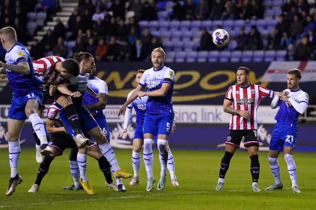 TARGET PRACTICE: Sheffield United's John Egan (left) rises to score his side's first goal of the game at the DW Stadium against Wigan Picture: Tim Goode PA.
