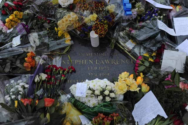 Flowers are pictured around a memorial stone in Eltham in south London, on January 4, 2012, where black teenager Stephen Lawrence was murdered in 1993.  (Photo: CARL COURT/AFP via Getty Images)