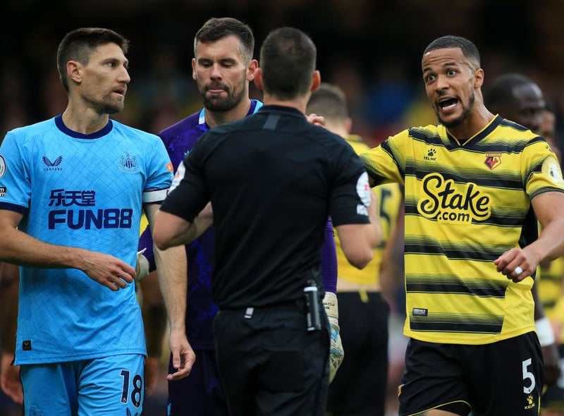 William Troost-Ekong of Watford FC and Federico Fernandez of Newcastle United interact with Match Referee, Jarred Gillett during the Premier League match between Watford and Newcastle United at Vicarage Road on September 25, 2021 in Watford, England.