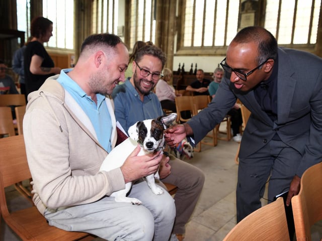 Revd Rob Sueka blessing a dog.