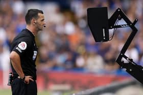 Yorkshire referee Andrew Madley consults the pitch side monitor for a VAR decision. Picture: PA Wire.