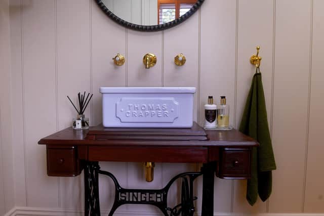 The cloakroom with upcycled singer sewing machine as a base and a Thomas Crapper sink