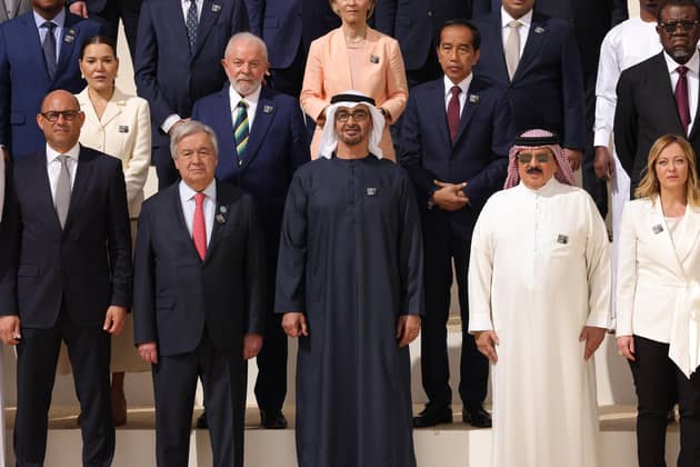Sultan Ahmed Al Jaber (C), President of the UNFCCC COP28 Climate Conference, stands with other leaders, including Simon Stiell (L), Executive Secretary of the United Nations Framework Convention on Climate Change (UNFCCC), Antonio Guterres (2L), Secretary-General of the United Nations, King of Bahrain Hamad bin Isa Al Khalifa (2R), and Italian Prime Minister Giorgia Meloni (R) during a family photo of heads of state during day one of the high-level segment of the UNFCCC COP28 Climate Conference at Expo City Dubai on December 01, 2023 in Dubai, United Arab Emirates.  (Photo by Sean Gallup/Getty Images)