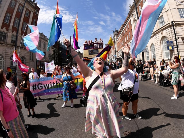 Pride-goers waved flags and celebrated as the parade passed Leeds Town Hall