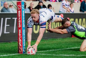 OVER THE TOP: Wakefield Trinity's Lachlan Walmsley scores the first of his two tries against Catalans Dragons at Belle Vue on Saturday. Picture by Alex Whitehead/SWpix.com