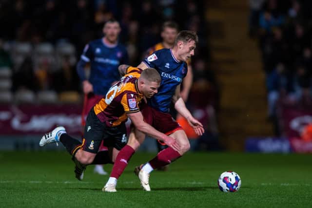 Adam Clayton challenges Owen Moxon in Bradford City's recent League Two home game with Carlisle United. Picture: Bruce Rollinson.