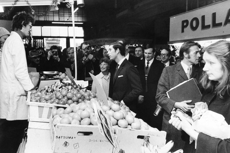 Prince Charles chats to a greengrocer in Kirkgate Market, Leeds, during his walkabout in December 1975.