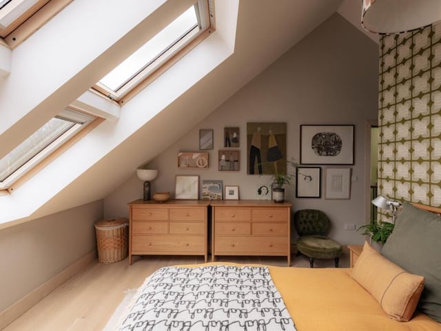 A vaulted ceiling with a series of skylights floods the principal bedroom with natural light, creating a bright and airy retreat.