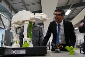 Prime Minister Rishi Sunak is shown a 3-D printed model of an All Terrain Armoured Transport Walker from Star Wars, made by apprentices, during a visit to the UK Atomic Energy Authority, Culham Science Centre, Abingdon, Oxfordshire, for a discussion on energy security and net zero. Picture date: Thursday March 30, 2023. PA Photo. Photo credit should read: Jacob King/PA Wire
