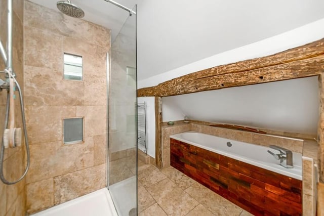 The bathroom makes the most of the old beams