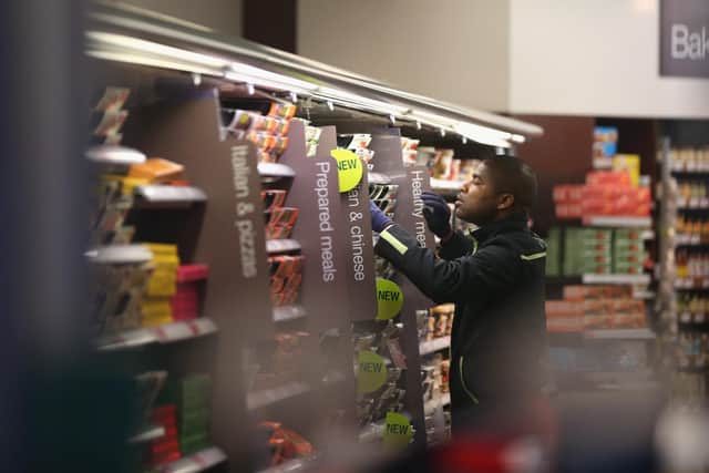 An employee restocks the shelves in a 'Simply Food' branch of Marks & Spencer in London.  (Photo by Oli Scarff/Getty Images)