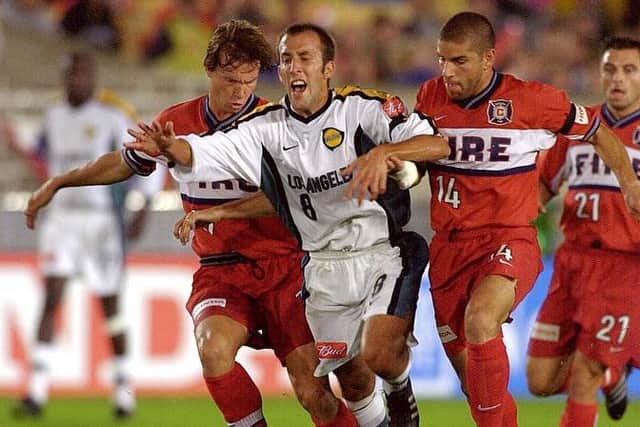 PARTNERS: Jesse Marsch (left) and new Leeds United assistant coach Chris Armas tackle Peter Vangenas in their days as Chicago Fire team-mates