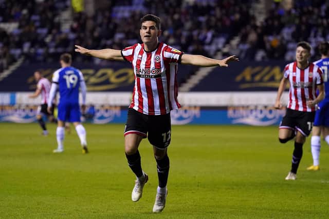 TEAMWORK: Sheffield United's John Egan celebrates scoring his side's first goal of the game at the DW Stadium against hosts Wigan Athletic. Picture: Tim Goode/PA