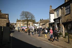 Locals and tourists enjoying the afternoon sunshine in Grassington. (Pic credit: Oli Scarff / Getty Images)