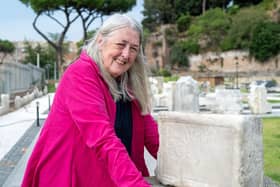 Mary Beard with the tombstone of Nero's nanny, Claudia Egloge, Rome. Picture: BBC/Lion Television/Russell Barnes.
