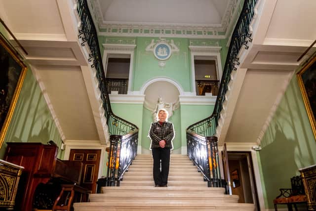 Behind The Scenes at Sledmere House, Sledmere, between Driffield and Malton, in North Yorkshire. Pictured Gwynneth Clark, a steward at the house for over 16 years, on the main staircase. Picture By Yorkshire Post Photographer,  James Hardisty.
