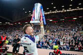 Tom Johnstone celebrates with the trophy in front of the Wakefield fans. (Photo: Callum Pilkington/SWpix.com)