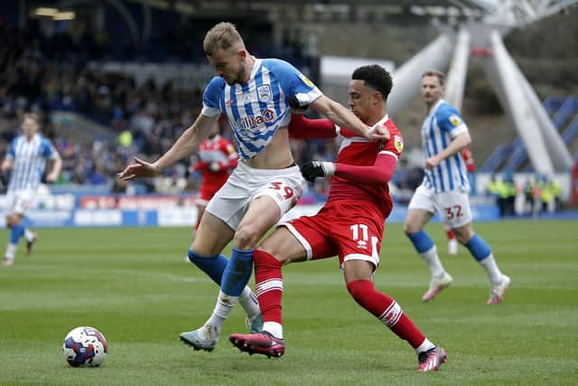 BATTLING: Huddersfield Town's Michal Helik and Middlesbrough's Aaron Ramsey get up close and personal at the John Smith's Stadium Picture: Will Matthews/PA