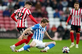 SCRAP: Sunderland's Trai Hume battles with Huddersfield Town's Jack Rudoni at the Stadium of Light on Tuesday night Picture: Owen Humphreys/PA