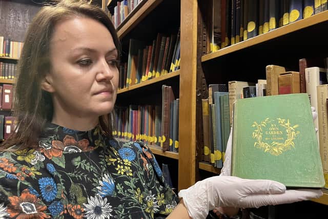 A rare book laced with a deadly poison has been discovered by librarians in Leeds as part of a global search for the toxic texts stashed on shelves across the world. Pictured with senior librarian Rhian Isaac.