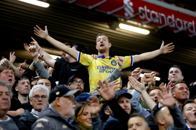 Leeds United fans celebrate after Rodrigo Moreno scores their side's first goal of the game during the Premier League match at Anfield, Liverpool.