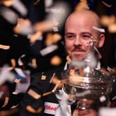 Luca Brecel of Belgium celebrates with the Cazoo World Snooker Championship trophy. (Photo by George Wood/Getty Images)
