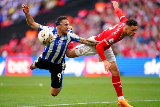 BATTLE: Sheffield Wednesday's Lee Gregory (left) and Barnsley's Jordan Williams compete for the ball during the League One play-off final