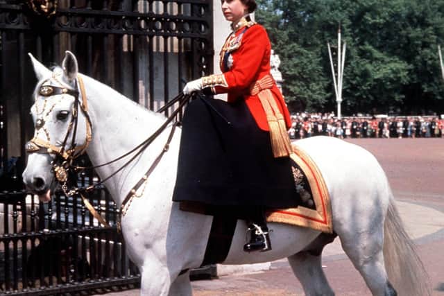The Queen riding side-saddle as she returns to Buckingham Palace, London, in 1963 after attending the Trooping the Colour ceremony on Horse Guards Parade. The parade is held in honour of the Queen's birthday.
