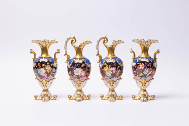 Heavily gilded vases finely painted with flowers, which stand just  8 ½ inches high, with a pair of matching ewers with acanthus-shaped feet