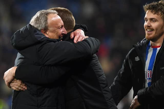 Terriers Neil Warnock and Ronnie Jepson hug on the final whistle after securing Championship football for Huddersfield (Picture: Jonathan Gawthorpe)