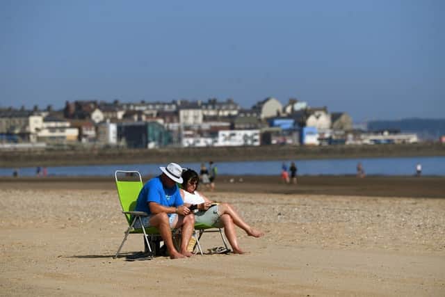 A couple enjoy the hot weather on Bridlington beach. (Pic credit: Jonathan Gawthorpe)