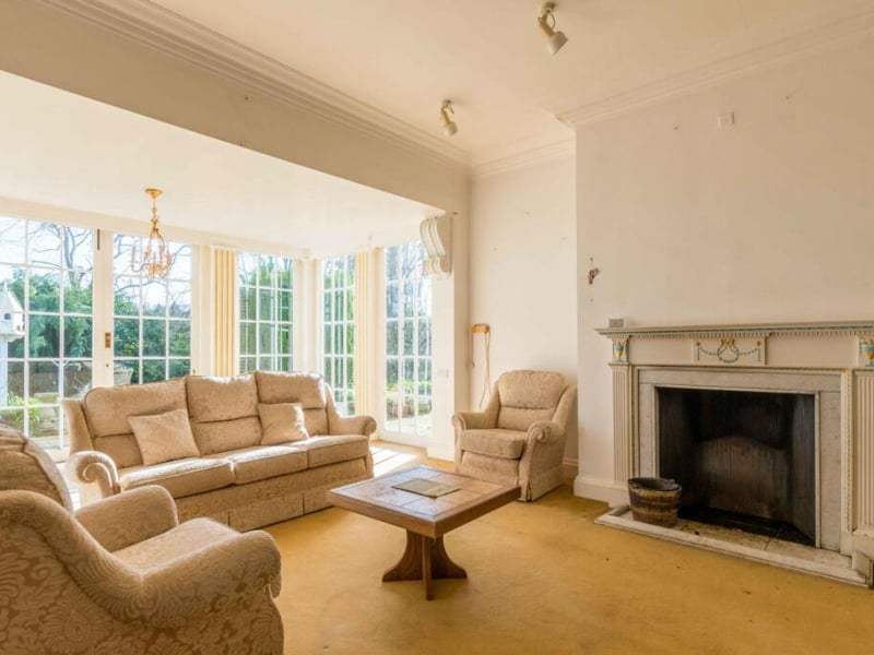 A sitting room with period fireplace