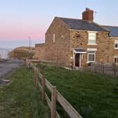 A view of the lane before it descends into Staithes harbour via Cowbar Bank with the end cottage due to be demolished seen on the right.
