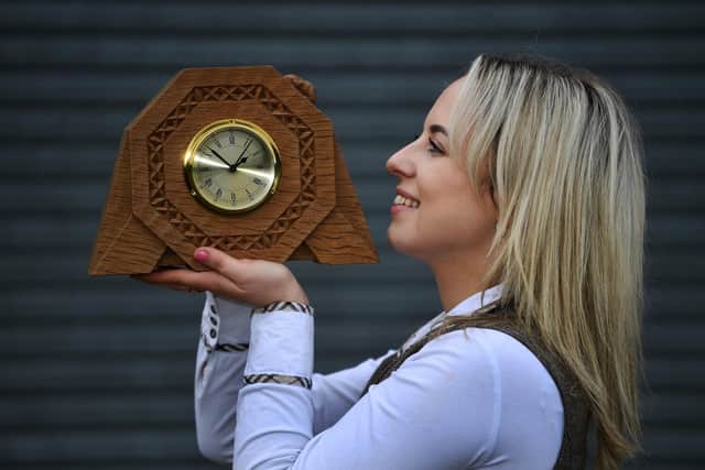 Eleanor Williams with a Robert Mouseman Thompson octagonal mantel clock.