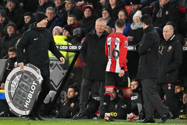 HOOKED: Oliver Norwood was the first of four senior players substituted by Sheffield United manager Chris Wilder (second from left)