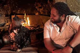Hamza Yassin sits at the fireside with a rescued African Crowned Eagle, Helen. Picture credit: BBC/Silverback Films/Pauline Kyalo