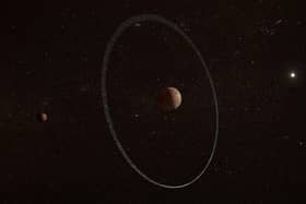 The rings are around Quaoar, which is a Pluto-sized dwarf planet orbiting beyond Neptune