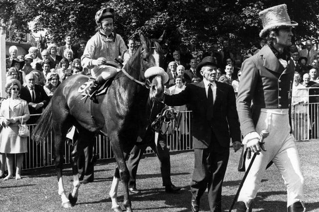 Jockey F. Burr is on his racehorse ‘Crazy Rhythm’ is led in after victory in the Ebor Handicap at York Racecourse in September 1972.