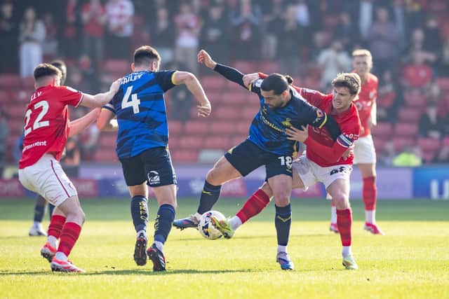 Barnsley captain Luca Connell (rights) challenged Doncaster Rovers midfielder - and ex-Reds player - Elliot Lee at Oakwell. Photo: Tony Johnson.