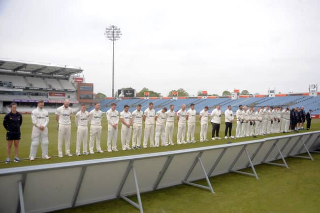 United in tribute: The players of Yorkshire and Glamorgan, the coaches and umpires, line up for a minute's silence in memory of Josh Baker prior to the County Championship match at Headingley on Friday. Picture: Dave Williams cricketphotos.co.uk