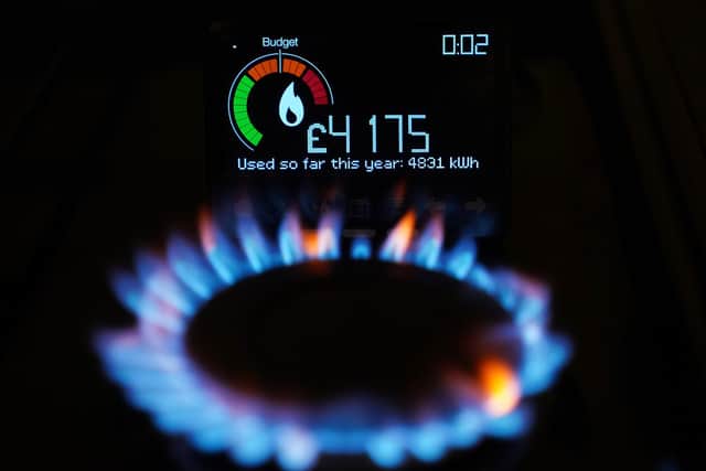 A file photo of a handheld smart meter on a kitchen hob showing the cost of a year-to-date's worth of home energy usage in a home. PIC: Yui Mok/PA Wire