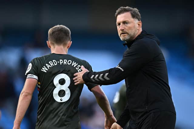 Southampton's Austrian manager Ralph Hasenhuttl congratulates Southampton's English midfielder James Ward-Prowse after the English Premier League football match between Manchester City and Southampton at the Etihad Stadium in Manchester, north west England, on October 8, 2022. (Photo by OLI SCARFF/AFP via Getty Images)