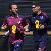 BALANCING ACT: England coach Gareth Southgate chats with John Stones at Sunday's training session