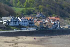 A couple take a walk on the beach at Sandsend. (Pic credit: Tony Johnson)