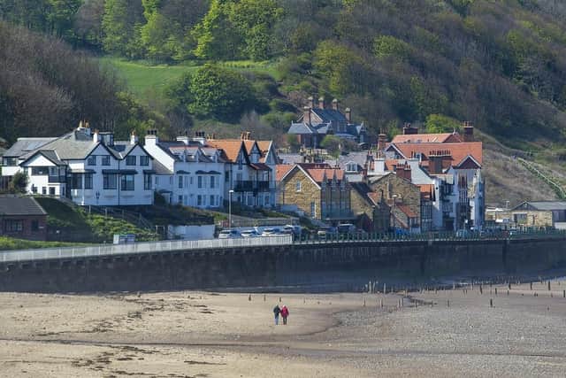 A couple take a walk on the beach at Sandsend. (Pic credit: Tony Johnson)