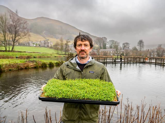 Jamie Roberts, with a tray of Alfalfa seedlings grown from bio products collected from their trout