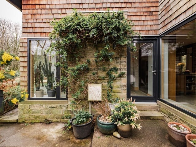 The back garden is largely laid to lawn, and borders are filled with ornamental grasses and hardy perennials.